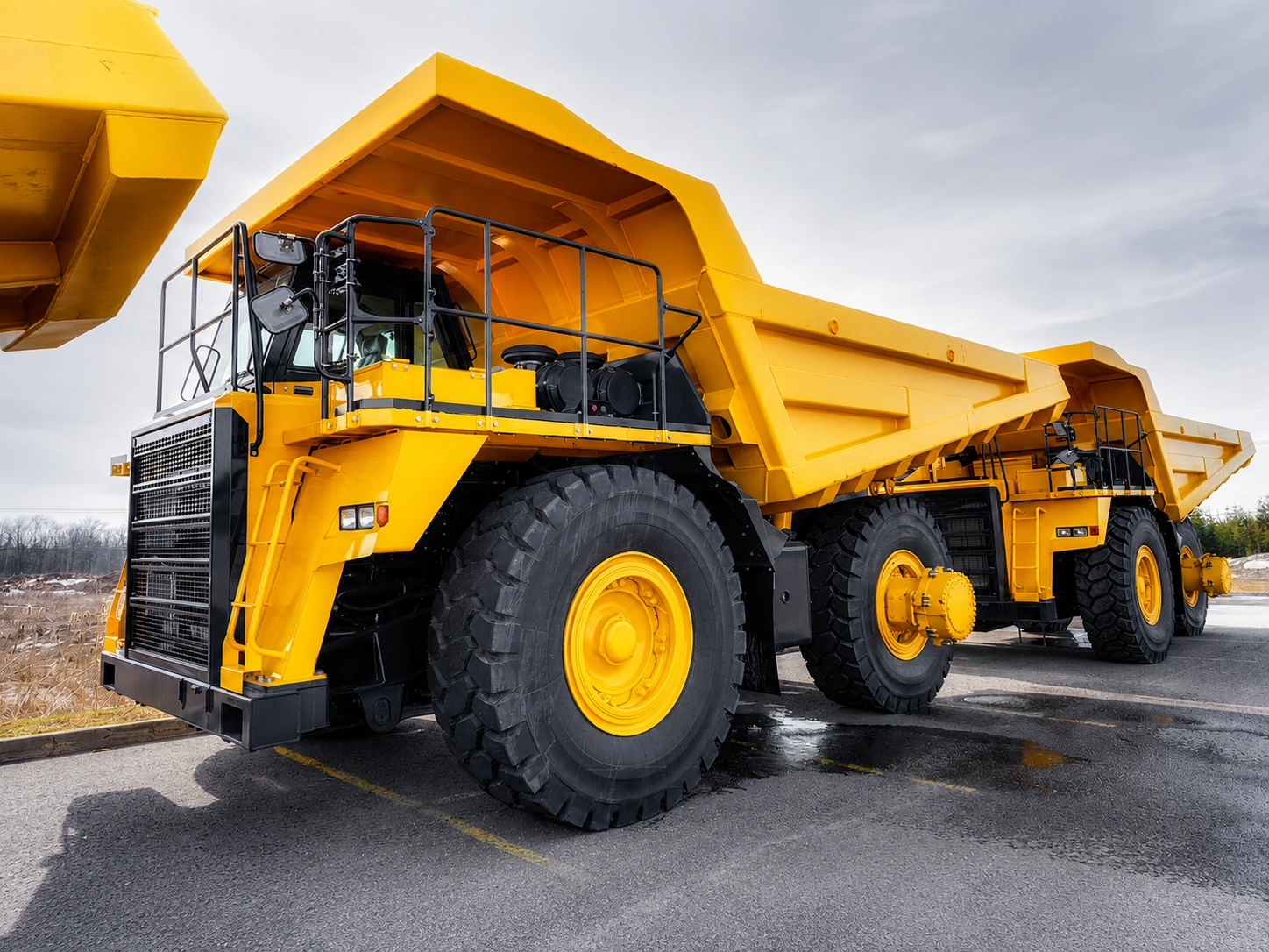 Large yellow heavy-duty mining haul truck with oversized tires designed for open-pit mining and industrial material transport